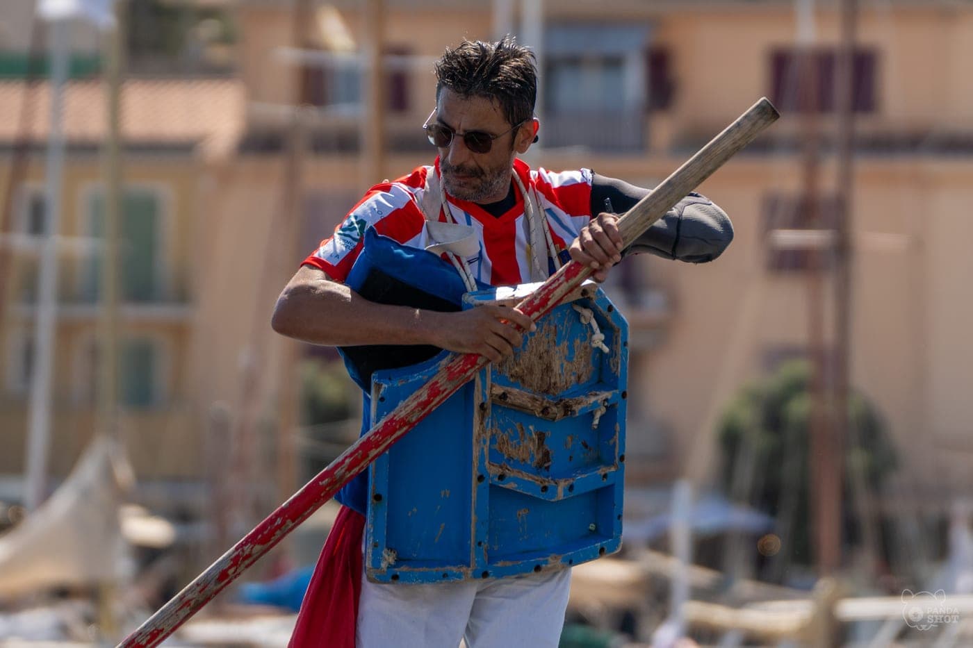 Un jouteur provençal, pavois et lance en main, dans le port.